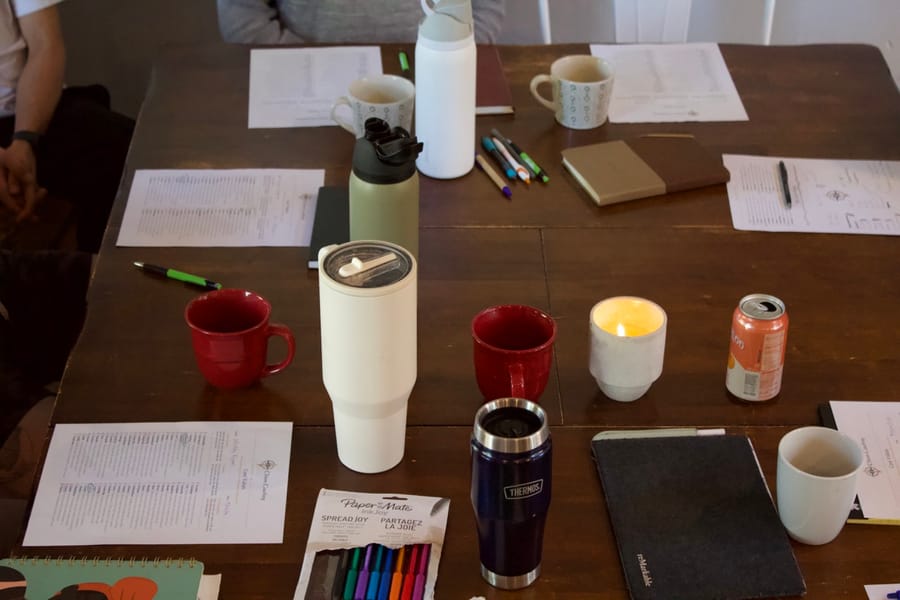 Worksheets, mugs and a candle on the retreat table